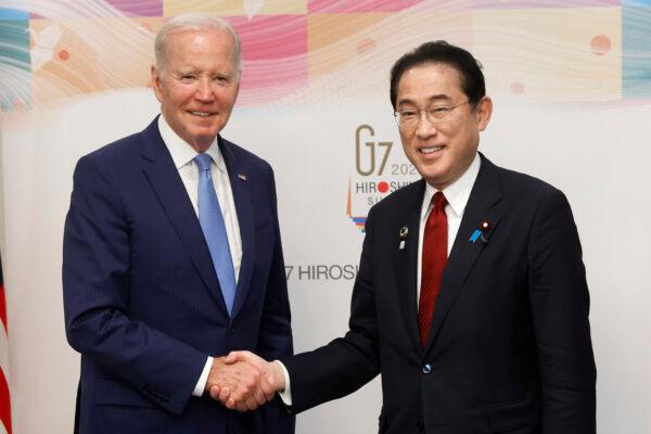 U.S. President Joe Biden (L) and Japanese Prime Minister Fumio Kishida shake hands prior to a bilateral meeting ahead of the Group of Seven leaders summit in Hiroshima, Japan, on May 18, 2023. (Kiyoshi Ota/Getty Images)