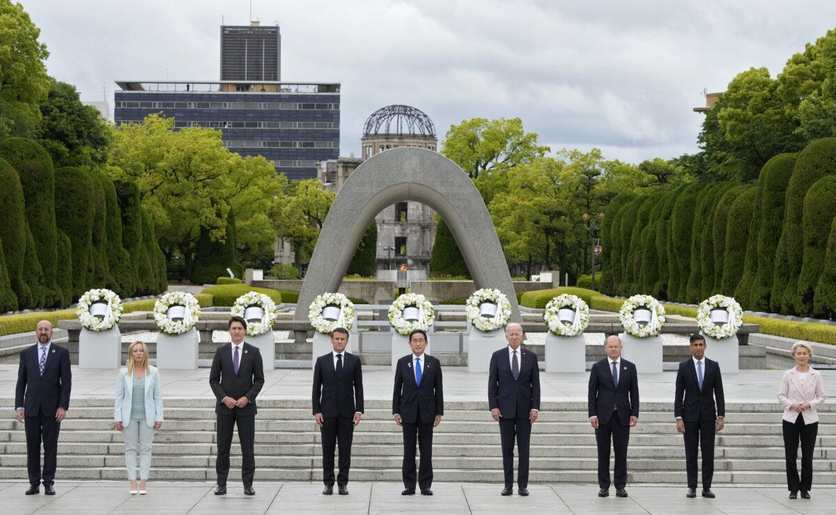 European Council President Charles Michel, Italian Prime Minister Giorgia Meloni, Canadian Prime Minister Justin Trudeau, French President Emmanuel Macron, Japanese Prime Minister Fumio Kishida, U.S. President Joe Biden, German Chancellor Olaf Scholz, British Prime Minister Rishi Sunak, and European Commission President Ursula von der Leyen pose for a group photo after laying flower wreaths at the Cenotaph for Atomic Bomb Victims in the Peace Memorial Park on the sidelines of the G-7 summit in Hiroshima, Japan, on May 18, 2023. (Franck Robichon - Pool/Getty Images)