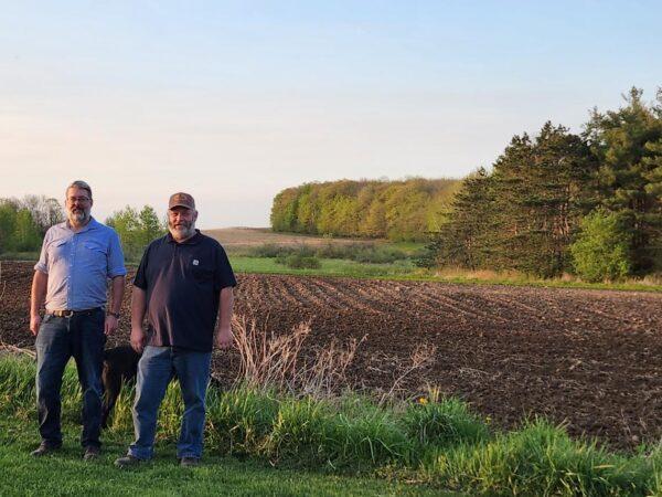 Martin Machtan and Tom Wilcox at a Wisconsin farm free of wind turbines, 2023. (Courtesy of Tom Wilcox)