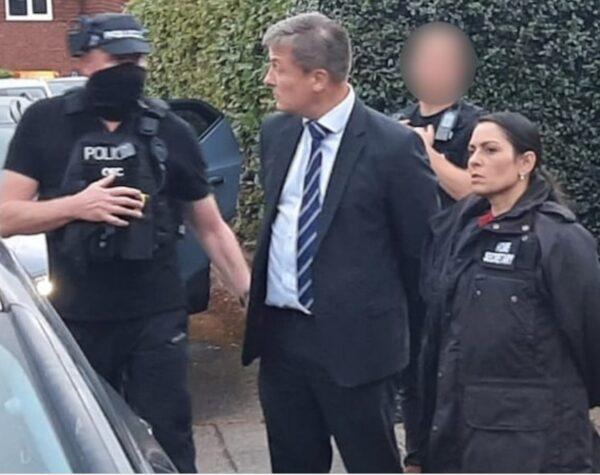The Home Secretary Priti Patel (R) accompanies National Crime Agency officers during the arrest of EncroChat suspects in Surrey, England in August 2022. (National Crime Agency)