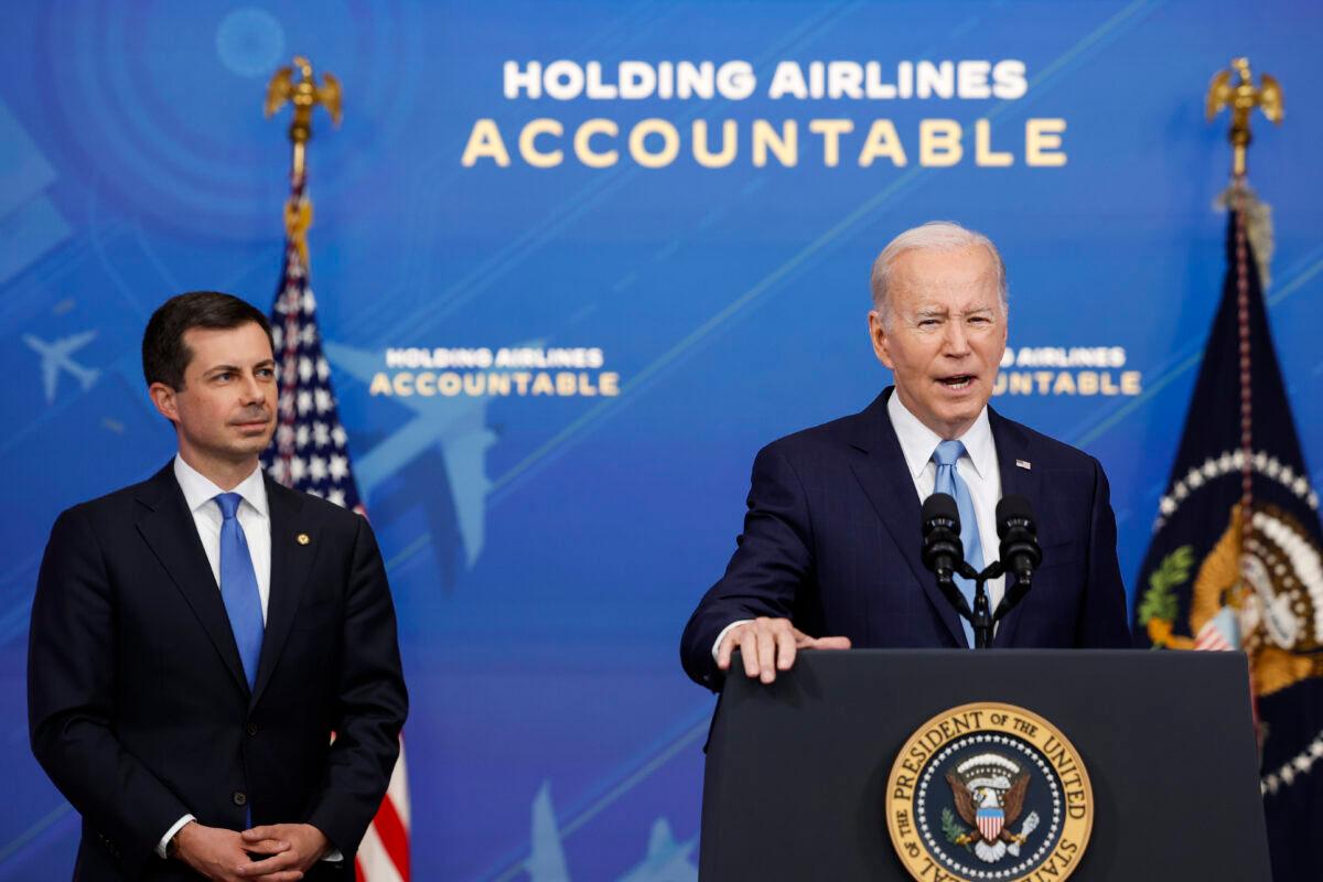 President Joe Biden speaks as Transportation Secretary Pete Buttigieg looks on at an announcement of new airline regulations in the South Court Auditorium on the White House campus in Washington on May 8, 2023. (Anna Moneymaker/Getty Images)