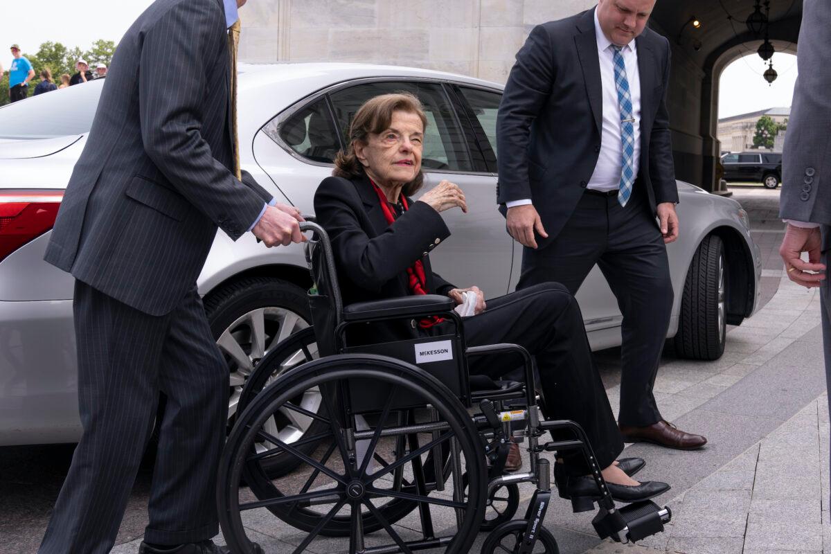 Sen. Dianne Feinstein (D-Calif.) is assisted to a wheelchair by staff as she returns to the Senate after a months-long absence, at the Capitol, on May 10, 2023. (J. Scott Applewhite/AP Photo)