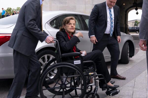 Sen. Dianne Feinstein (D-Calif.) is assisted to a wheelchair by staff as she returns to the Senate after a months-long absence, at the Capitol on May 10, 2023. (J. Scott Applewhite/AP Photo)