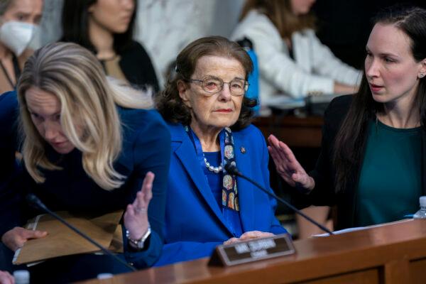 Sen. Dianne Feinstein is flanked by aides as she returns to the Senate Judiciary Committee following a more than two-month absence as she was being treated for a case of shingles, at the Capitol, on May 11, 2023. (J. Scott Applewhite/AP Photo)