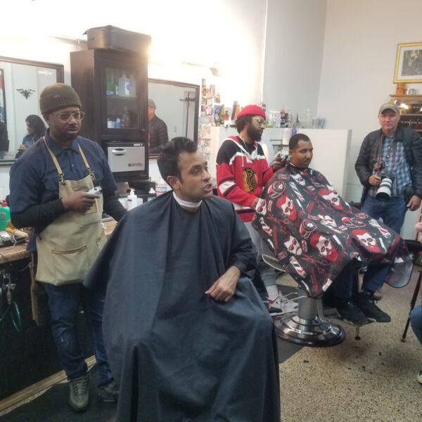 GOP presidential hopeful Vivek Ramaswamy speaks to Will Calloway at a barbershop in Chicago on May 19, 2023. (Nathan Worcester/The Epoch Times)