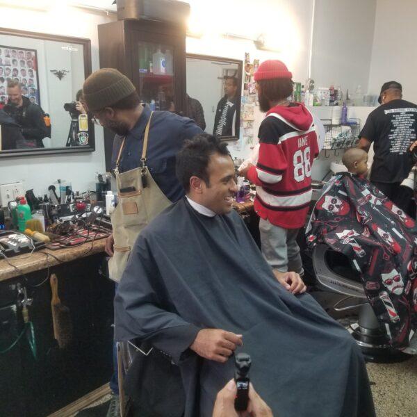 Vivek Ramaswamy visits a barbershop in Chicago's South Shore neighborhood on May 19, 2023. It was one stop on the presidential hopeful's tour of the neighborhood after locals protested the possible arrival of hundreds of migrants to a shuttered high school. (Nathan Worcester/The Epoch Times)