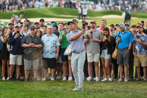 Bryson DeChambeau of the United States plays his third shot on the fourth hole as fans look on during the second round of the 2023 PGA Championship at Oak Hill Country Club in Rochester, N.Y., on May 19, 2023. (Andy Lyons/Getty Images)