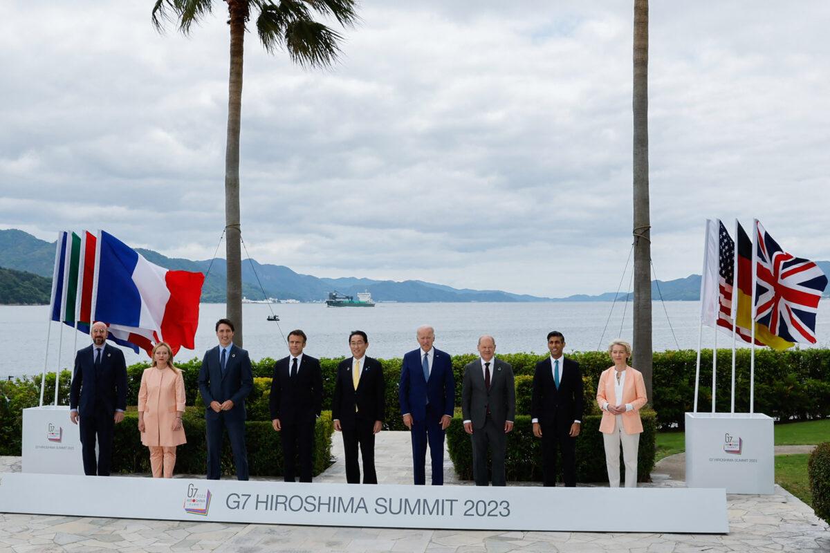 (L–R) European Council President Charles Michel, Italian Prime Minister Giorgia Meloni, Canadian Prime Minister Justin Trudeau, French President Emmanuel Macron, Japanese Prime Minister Fumio Kishida, U.S. President Joe Biden, German Chancellor Olaf Scholz, UK Prime Minister Rishi Sunak, and European Commission President Ursula von der Leyen participate in a family photo with G-7 leaders before their working lunch meeting on economic security at the Grand Prince Hotel in Hiroshima, Japan, on May 20, 2023. (Jonathan Ernst/POOL/AFP via Getty Images)