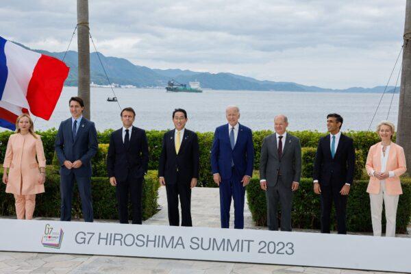 (L-R) Italian Primer Minister Giorgia Meloni, Canadian Prime Minister Justin Trudeau, French President Emmanuel Macron, Japanese Prime Minister Fumio Kishida, U.S. President Joe Biden, German Chancellor Olaf Scholz, UK Prime Minister Rishi Sunak, and European Commission President Ursula von der Leyen participate in a family photo with G-7 leaders before their working lunch meeting on economic security at the Grand Prince Hotel in Hiroshima, Japan, on May 20, 2023. (JONATHAN ERNST/POOL/AFP via Getty Images)