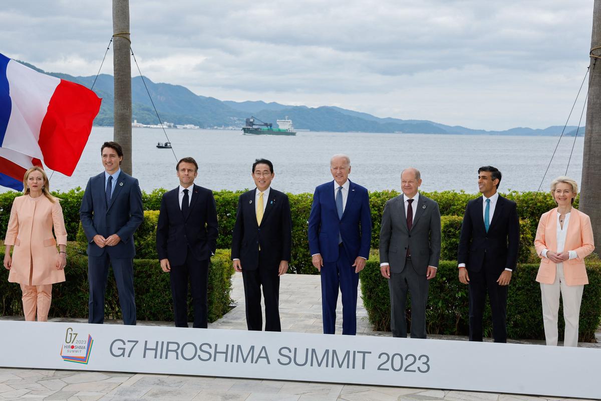 (L-R) Italy's Primer Minister Giorgia Meloni, Canada's Prime Minister Justin Trudeau, France's President Emmanuel Macron, Japan's Prime Minister Fumio Kishida, US President Joe Biden, German Chancellor Olaf Scholz, Britain's Prime Minister Rishi Sunak and European Commission President Ursula von der Leyen participate in a family photo with G7 leaders before their working lunch meeting on economic security at the Grand Prince Hotel in Hiroshima on May 20, 2023. (Jonathan Ernst/AFP via Getty Images)