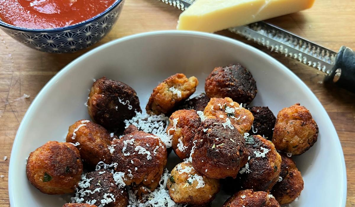 Polpetti di Pane, or bread meatballs, can be served with tomato sauce or wedges of lemon. (Gretchen McKay/Pittsburgh Post-Gazette/TNS)