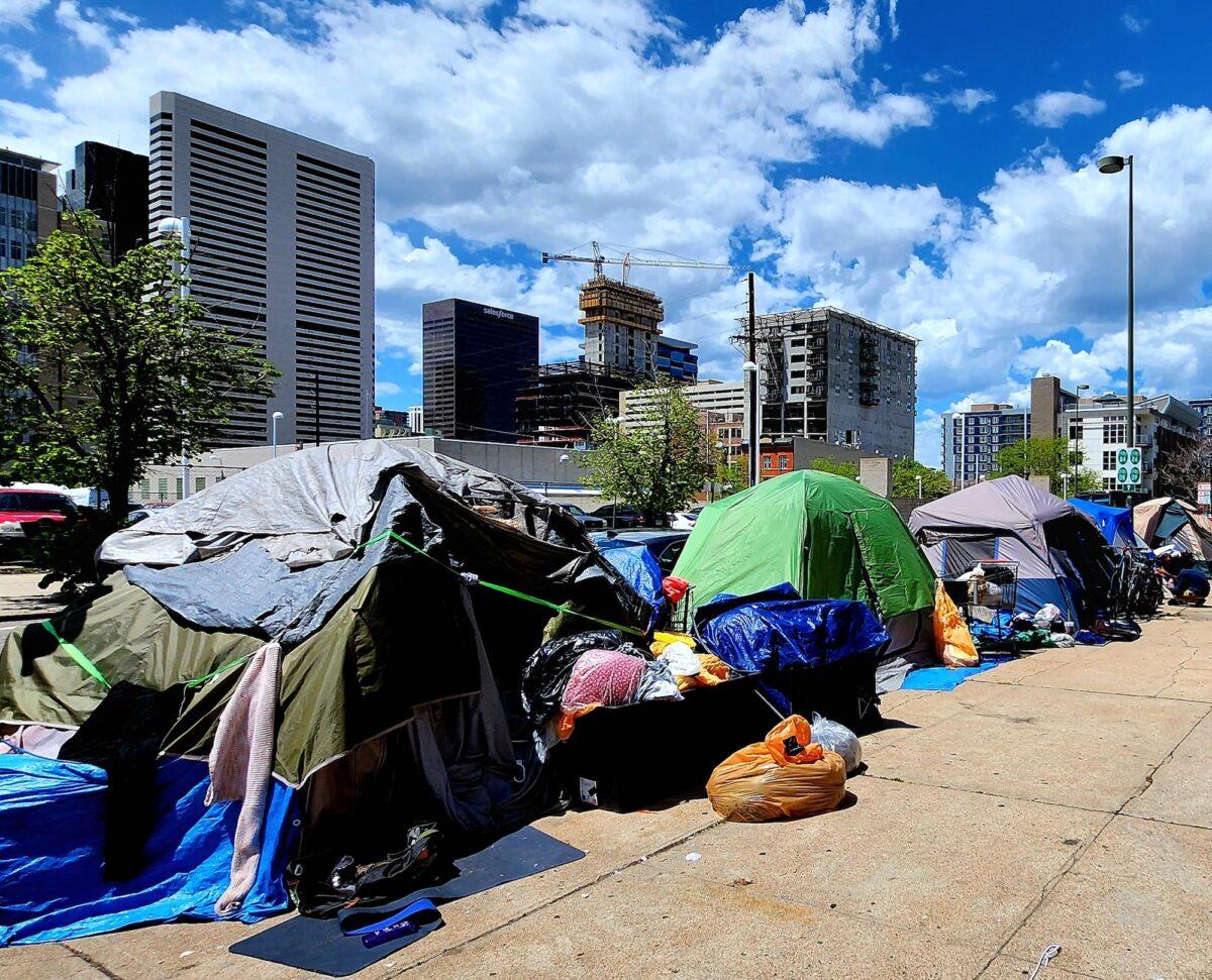 The sidewalk on 21st Street is a tent enclave for homeless people in Denver, Colo., on May 17, 2023. (Allan Stein/The Epoch Times)
