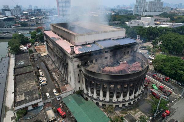 Smoke billows from the still smoldering Manila Central Post Office in Manila, Philippines, on, May 22, 2023, after a massive fire tore through. (AP Photo/Aaron Favila)