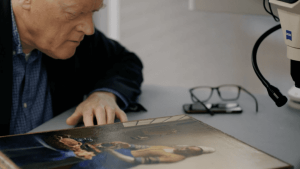 Dr. Gregor J.M. Weber, the art director at the Rijksmuseum, examines the Vermeer painting "The Milkmaid" in the documentary “Close to Vermeer.” (Courtesy of Kino Lorber)