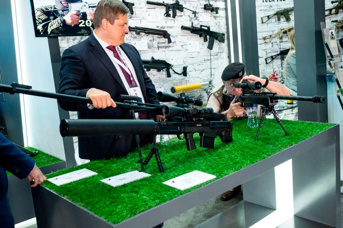 A member of the South African Defence Force looks at the Mts-116M sniper rifle manufactured by Russia's JSC Konstruktorskoe Buro Priborostroeniya (KBP) during the Africa Aerospace and Defence Expo on Sept. 20, 2018, at South Africa's Waterkloof Air Force base, on the outskirts of Pretoria. (Wikus De Wet/AFP via Getty Images)