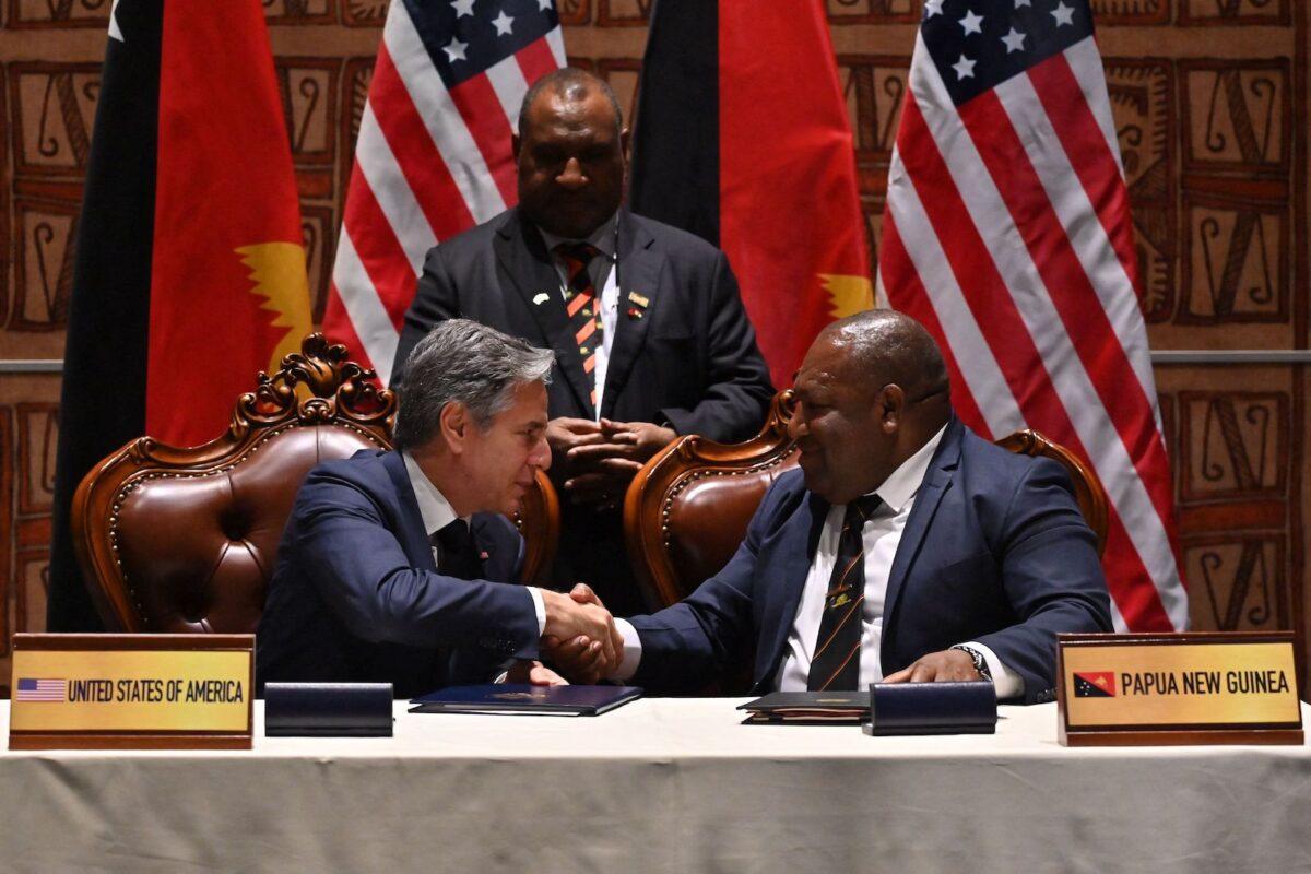 U.S. Secretary of State Antony Blinken and Papua New Guinea's defense minister, Win Bakri Daki, shake hands after signing a security agreement as Papua New Guinea's prime minister, James Marape (C), looks on at the Forum for India–Pacific Islands Cooperation at APEC Haus in Port Moresby, Papua New Guinea, on May 22, 2023. (Adek Berry/AFP via Getty Images)