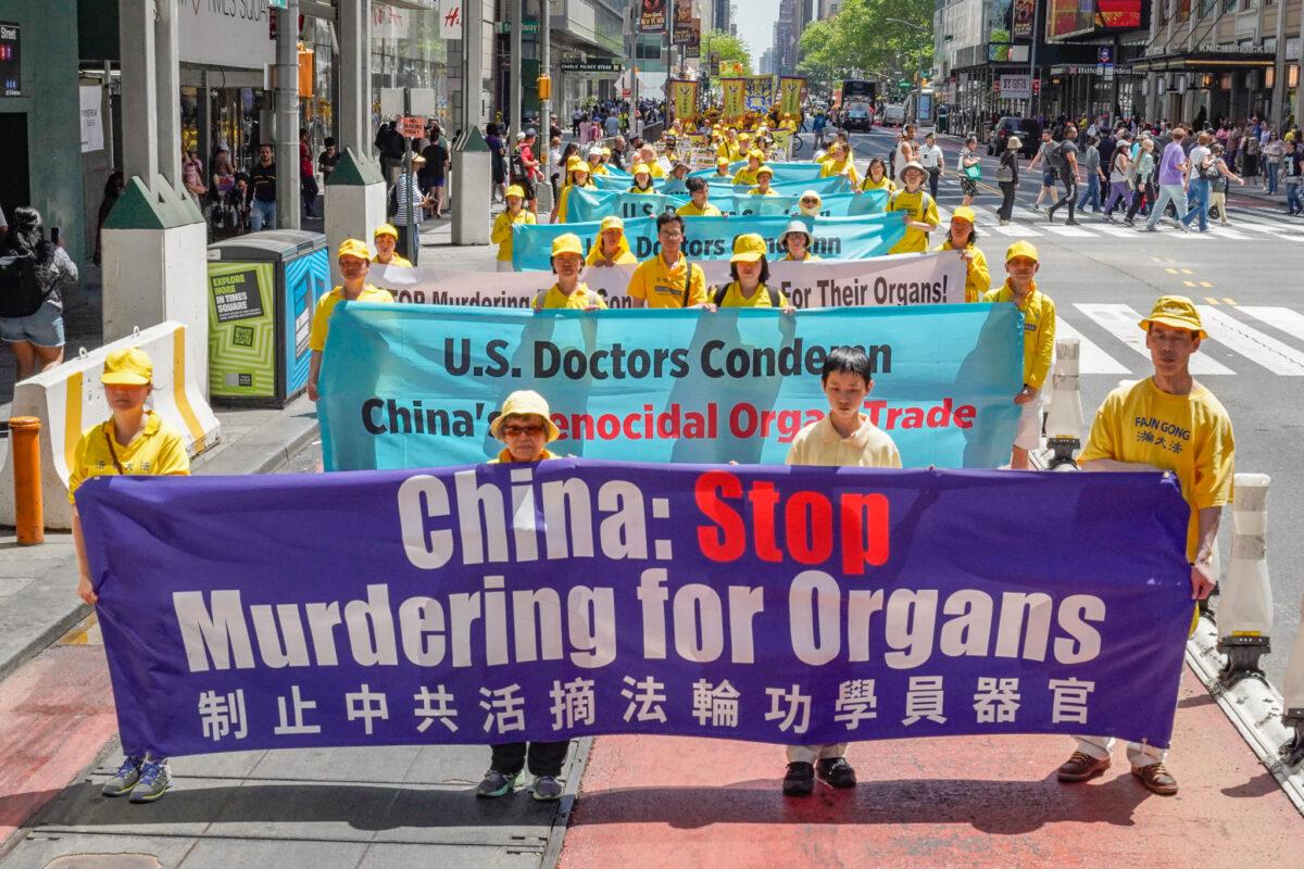 Falun Gong practitioners march in Manhattan to celebrate World Falun Dafa Day in New York on May 12, 2023. (Larry Dye/The Epoch Times)