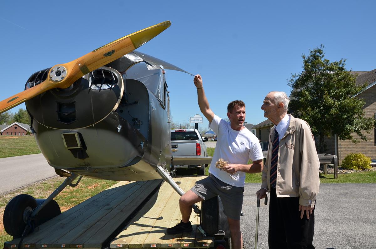 Edwin Smith talks flight stories with Calvin Wiley, owner of a WWII tail dragger, a 1941 L-9B Stinson. (Tracey Sharber)