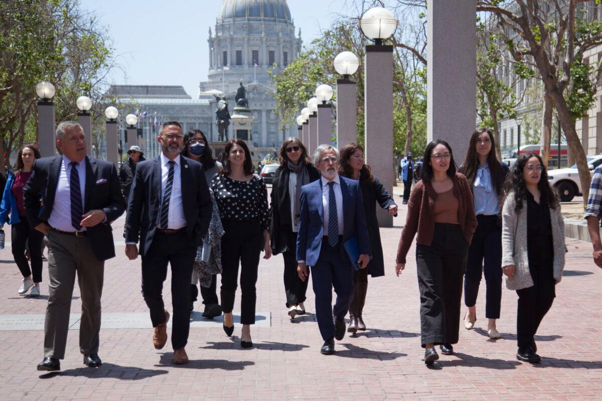 The San Francisco Board of Supervisors walks toward an outdoor meeting in U.N. Plaza, San Francisco, on May 23, 2023. (Lear Zhou/The Epoch Times)