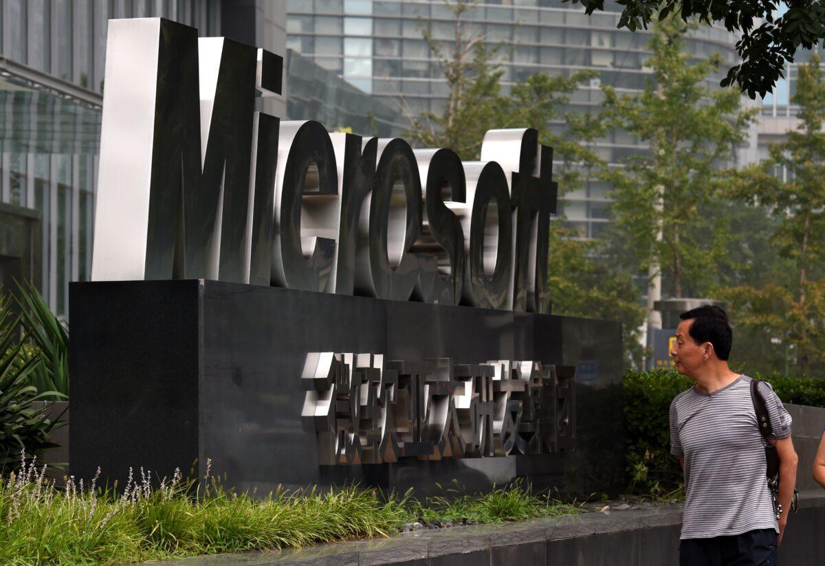 A man walks past a Microsoft sign outside the company's offices in Beijing on July 31, 2014. (Greg Baker/AFP via Getty Images)