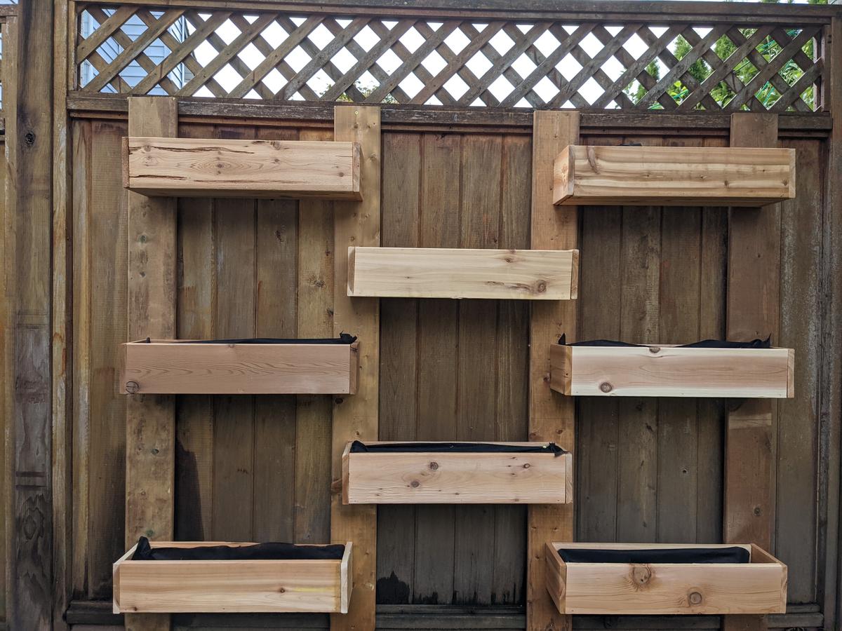 An idle fence with wooden planters mounted on it can be used as a food-growing zone. (Courtesy of Michael Major)