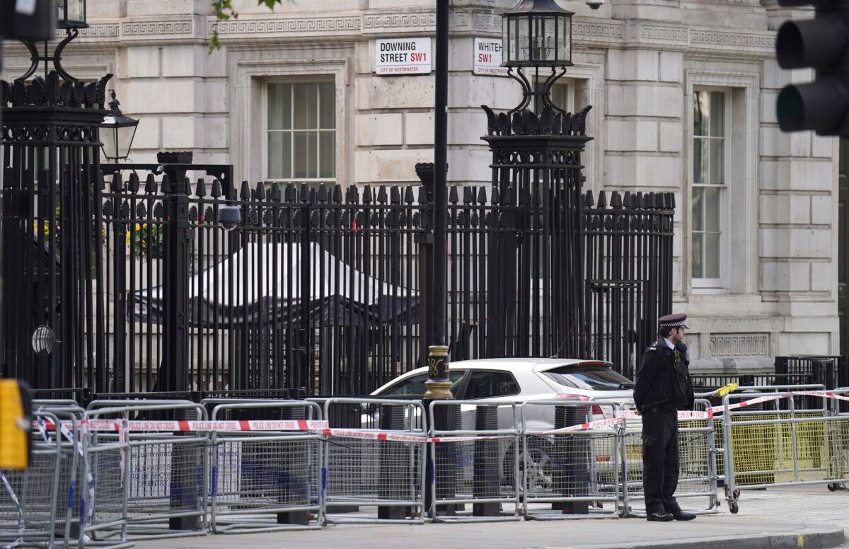Police at the scene after a car collided with the gates of Downing Street in London on May 25, 2023. (James Manning/PA via AP)