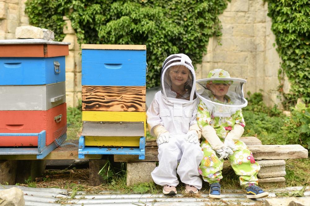 Beekeeping can be a family affair and is a great way for kids to learn about nature firsthand. (kipgodi/Shutterstock)
