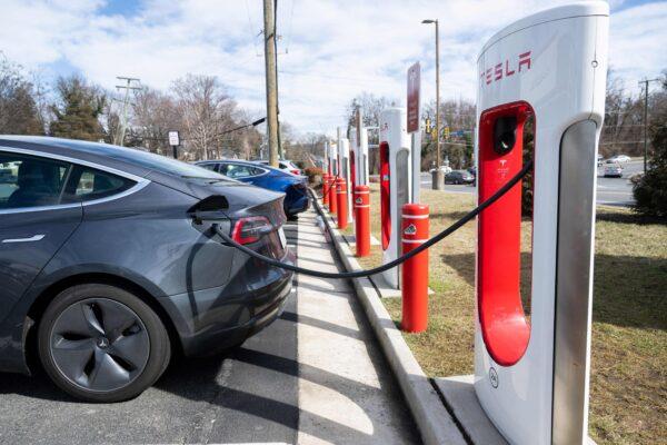 A Tesla Model S sedan is plugged into a Tesla Supercharger electrical vehicle charging station in Falls Church, Va., on Feb. 13, 2023. (SAUL LOEB/AFP via Getty Images)
