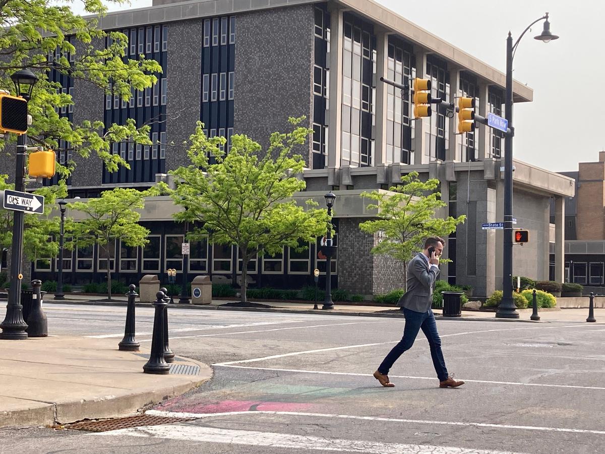 A pedestrian crosses the street in the city of Erie, Pa., on May 22, 2023. Erie County has long been considered a political “bellwether” county. (Janice Hisle/The Epoch Times)