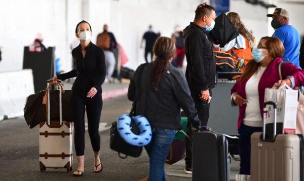 Travelers await ground transport on arrival at Los Angeles International Airport on May 27, 2021. (Frederic Brown/AFP via Getty Images)