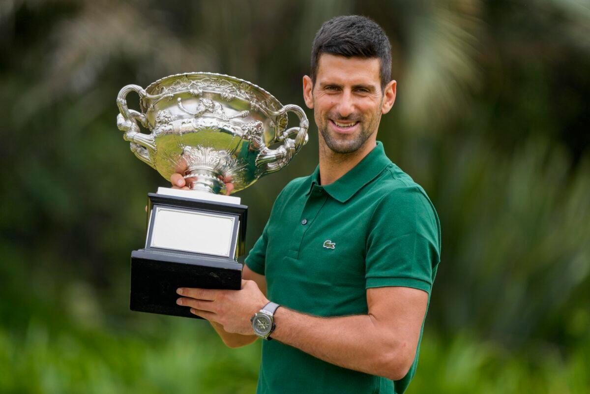 Novak Djokovic of Serbia poses with the Norman Brookes Challenge Cup in the gardens of Government House the morning after defeating Stefanos Tsitsipas of Greece in the men's singles final at the Australian Open tennis championship in Melbourne, Australia, on Jan. 30, 2023. (Mark Baker/AP Photo)