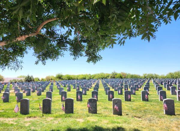 A sea of gravestones decked with flags at the Arizona Veterans' Memorial Cemetery in Marana, Ariz., on May 27, 2023. (Allan Stein/The Epoch Times)