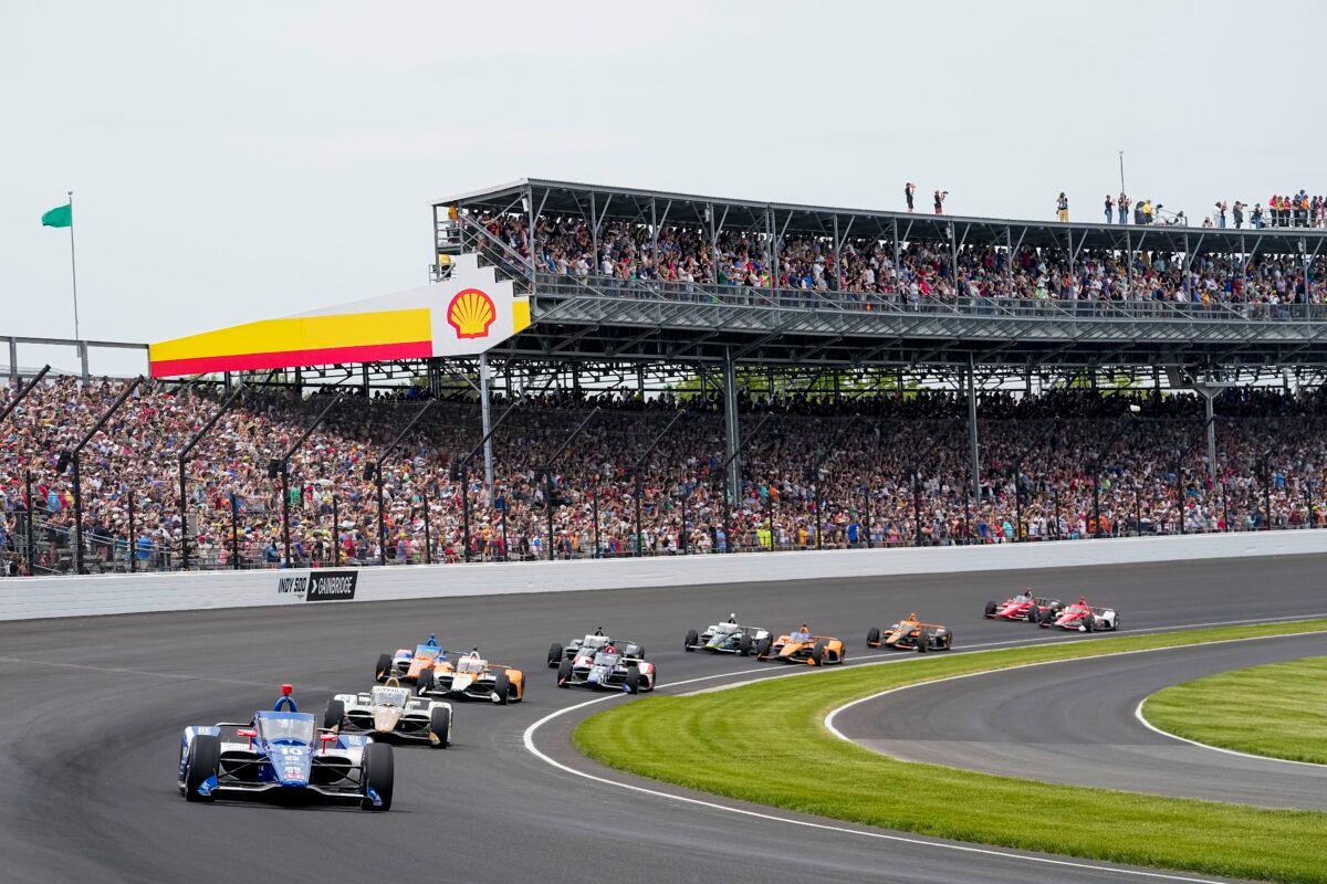 Cars take the first turn of the Indy 500 at Indianapolis Motor Speedway on May 28, 2023. (Darron Cummings/AP Photo)
