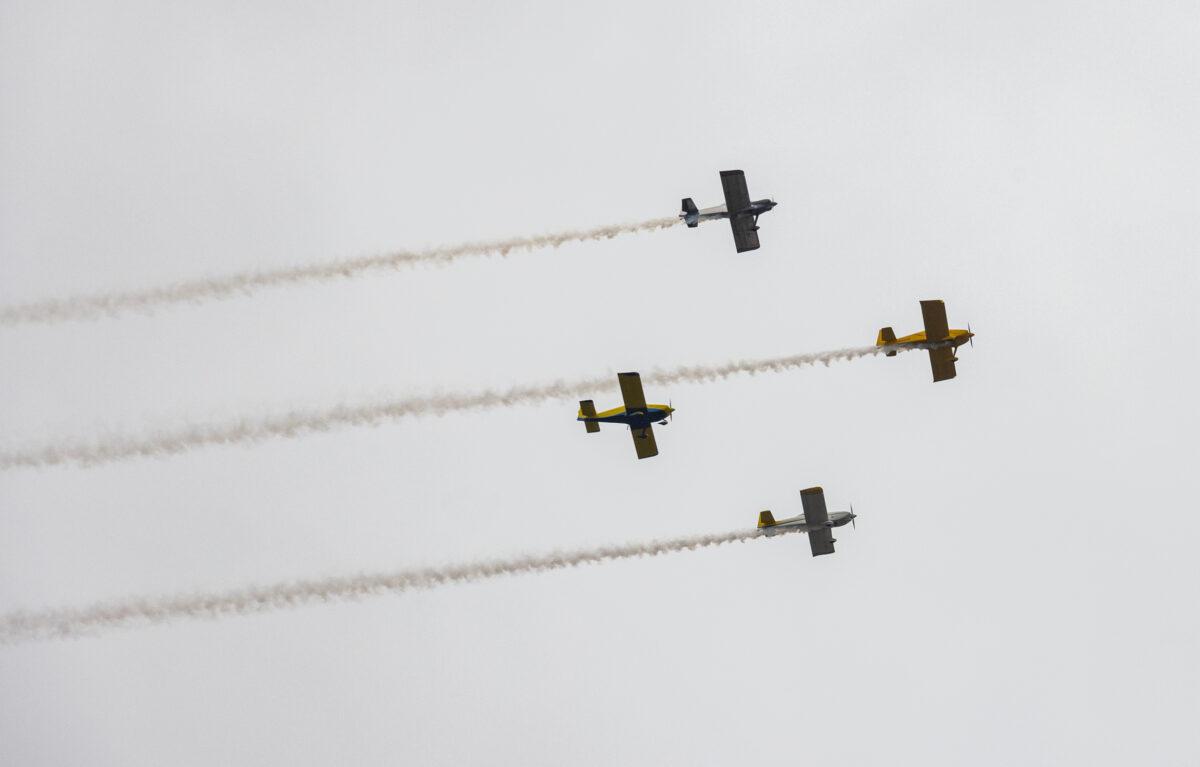 Vintage aircraft participate in a flyover as people gather for Memorial Day celebrations at Fairhaven Memorial Park in Santa Ana, Calif., on May 29, 2023. (John Fredricks/The Epoch Times)