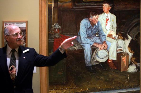 Museum guide Steve Gershoff speaks to visitors next to the copy of Norman Rockwell's painting titled "Breaking Home Ties," which has been hanging on display in the Norman Rockwell Museum in Stockbridge, Mass. (Joe Raedle/Getty Images)