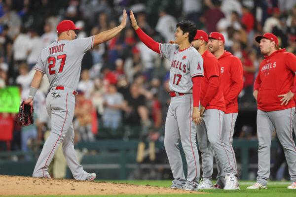 Mike Trout (27) and Shohei Ohtani (17) of the Los Angeles Angels high five after defeating the Chicago White Sox at Guaranteed Rate Field in Chicago on May 29, 2023. (Michael Reaves/Getty Images)