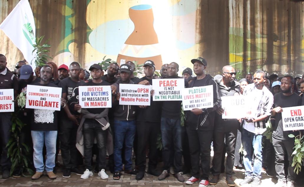 Youths display placards on 22 May during a protest in Jos, Plateau state, against ongoing massacre of Christians in Mangu. (Masara Kim/The Epoch Times)