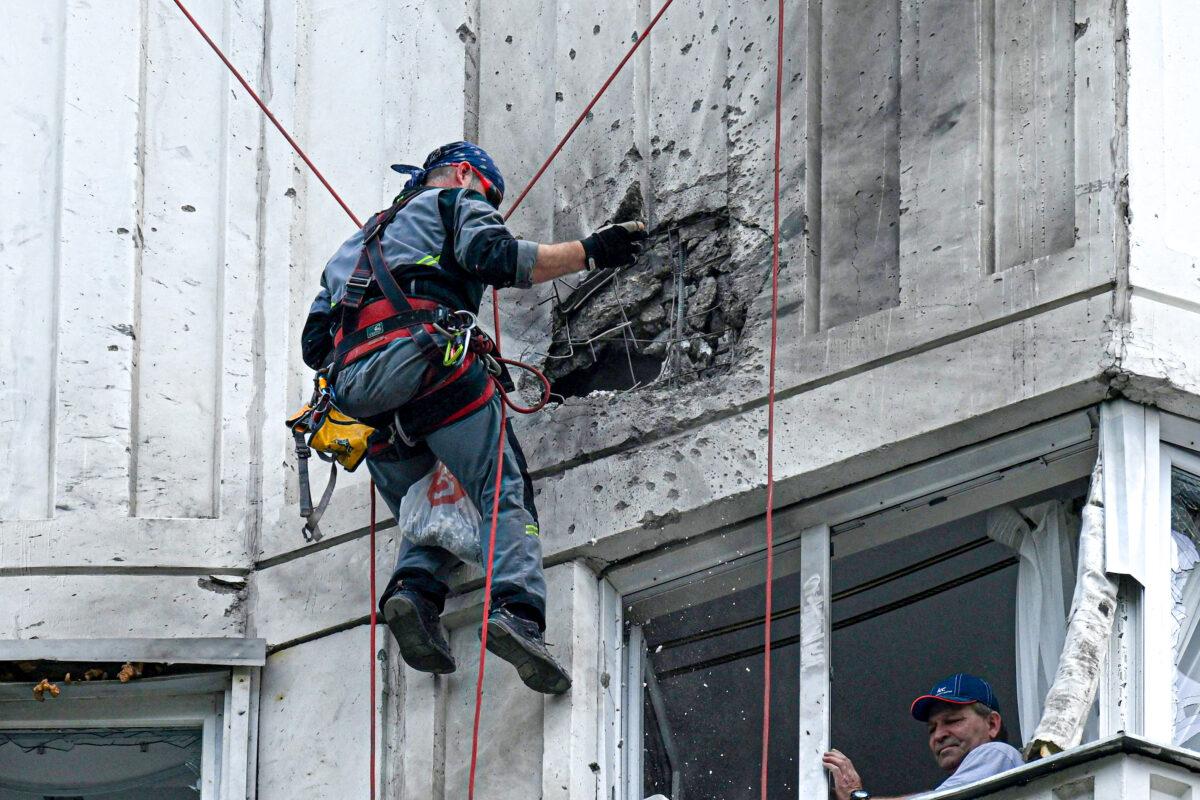A specialist inspects the damaged facade of a multi-storey apartment building after a reported drone attack in Moscow on May 30, 2023. (Kirill Kudryavtsev/AFP via Getty Images)