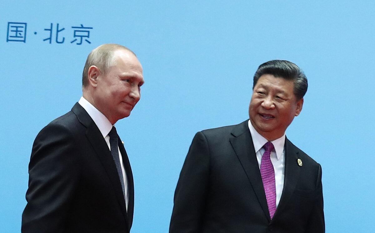 China's President Xi Jinping (R) and Russia's President Vladimir Putin smile during the welcoming ceremony on the final day of the Belt and Road Forum in Beijing, on April 27, 2019. (Valery Sharifulin/Sputnik/AFP via Getty Images)