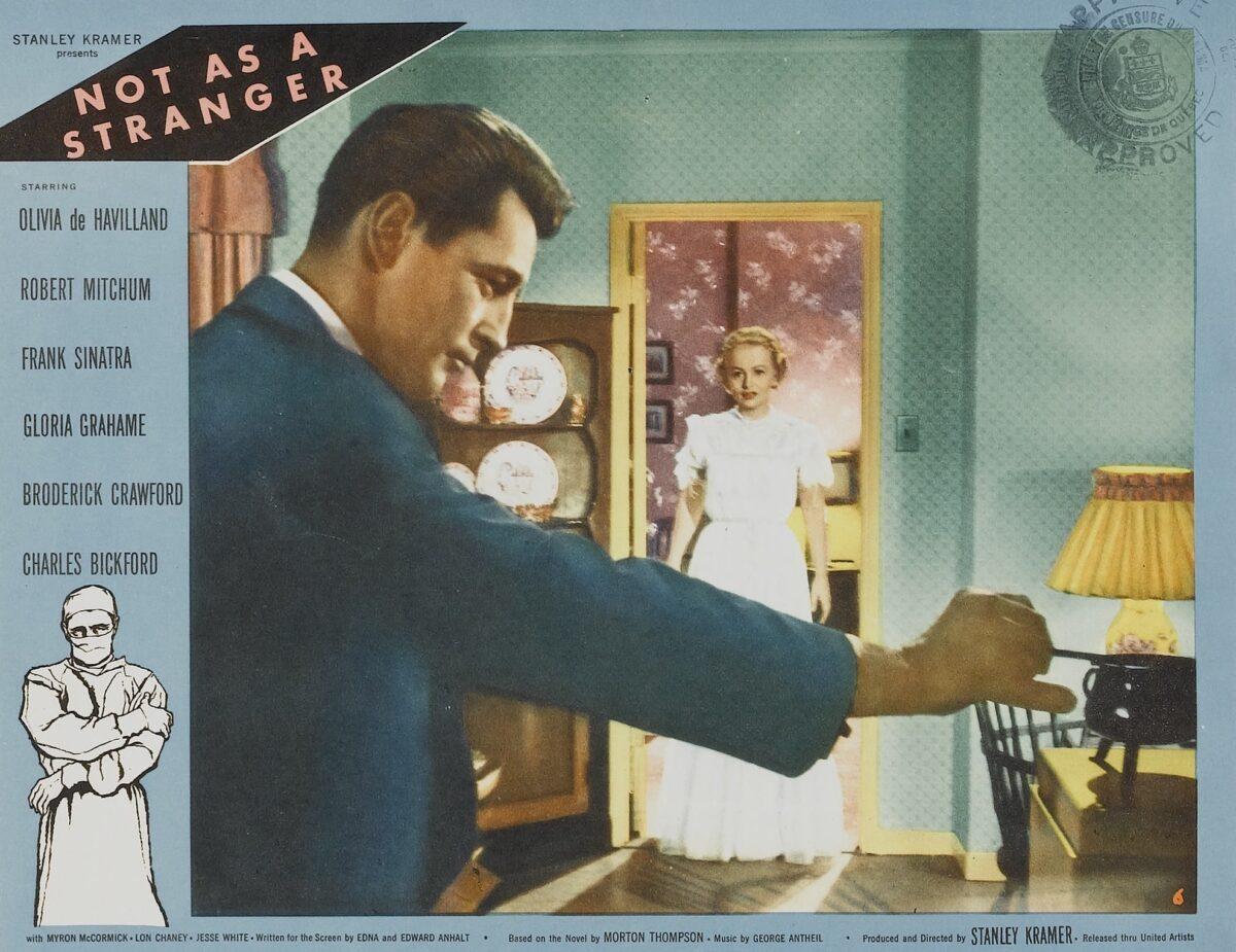 Cropped lobby card for the 1955 film "Not as a Stranger," starring Robert Mitchum and Olivia de Havilland. (MovieStillsDB)