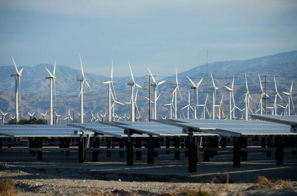 Giant wind turbines are powered by strong winds in front of solar panels in Palm Springs, Calif., on March 27, 2013. (Kevork Djansezian/Getty Images)