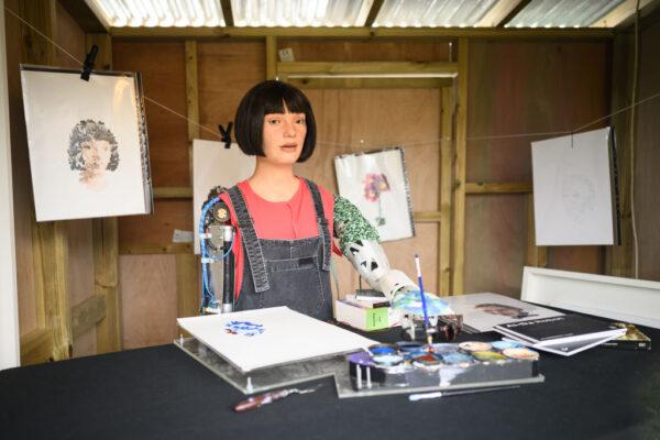 Ai-DA, the world's first robot artist, paints portraits of the headline acts in the Ai-DA Robot Booth in the Shangri La Field, during day two of Glastonbury Festival at Worthy Farm, Pilton in Glastonbury, England on June 23, 2022. (Leon Neal/Getty Images)
