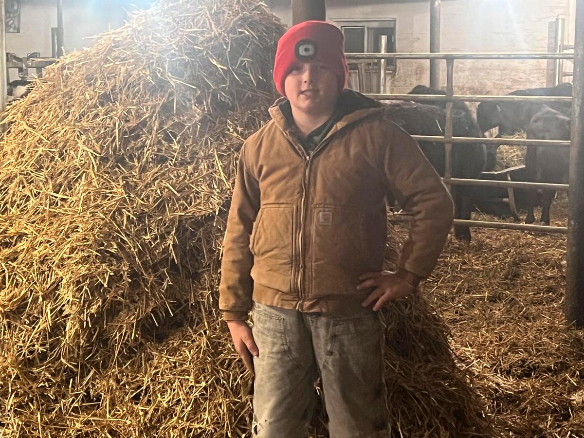 Caleb doing his daily chores of getting straw down from the upstairs hay mow and bedding the baby and feeder calves. (Courtesy of Jill Bergner)