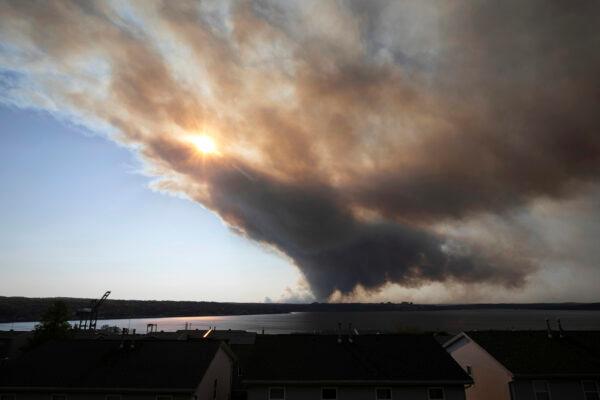 Thick plumes of heavy smoke fill the Halifax sky as an out-of-control fire in a suburban community quickly spread, engulfing multiple homes and forcing the evacuation of local residents in Halifax, Nova Scotia, Canada, on May 28, 2023. (Kelly Clark/The Canadian Press via AP)