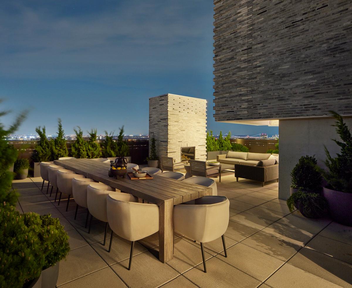 The extensive exterior areas include this alfresco dining and gathering area accented by a massive outdoor fireplace. (Sean Hemmerle)