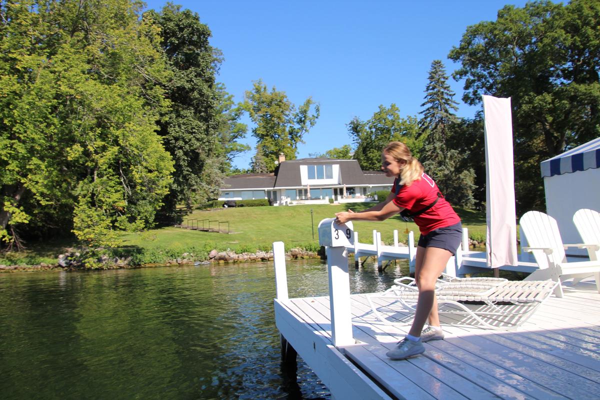 The mail to 75 homes is still delivered along Lake Geneva' shoreline via boat. Here, Paige Young, a so-called "mail jumper" quickly bounds between land and boat to deliver the mail. (Mary Ann Anderson/TNS)