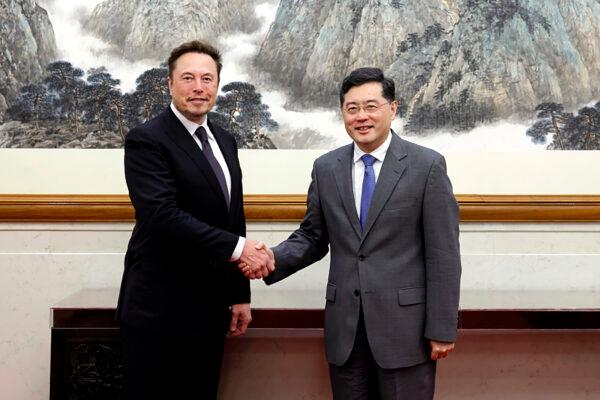 China's Foreign Minister Qin Gang, right, with Tesla Ltd. CEO Elon Musk in Beijing, China, on May 30, 2023. (Ministry of Foreign Affairs of the People's Republic of China via AP)
