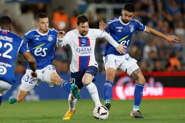 PSG's Lionel Messi (C) challenges for the ball with Strasbourg's Frederic Guilbert (L) and Strasbourg's Kevin Gameiro (R) during the French League One soccer match between Strasbourg and Paris Saint Germain at Stade de la Meinau stadium in Strasbourg, eastern France, on May 27, 2023. (Jean-Francois Badias/AP Photo)