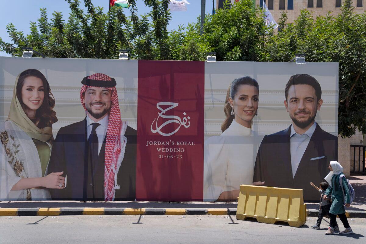 A poster with pictures of Crown Prince Hussein and his fiancee, Saudi architect Rajwa Alseif, is posted at a road in Amman, Jordan, on May 31, 2023. (Nasser Nasser/AP Photo)