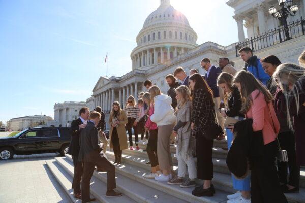 Sen. James Lankford (R-Okla.), second from left, leads a group of Sooner State college students in prayer on the U.S. Capitol steps. (Photo courtesy Lankford office).